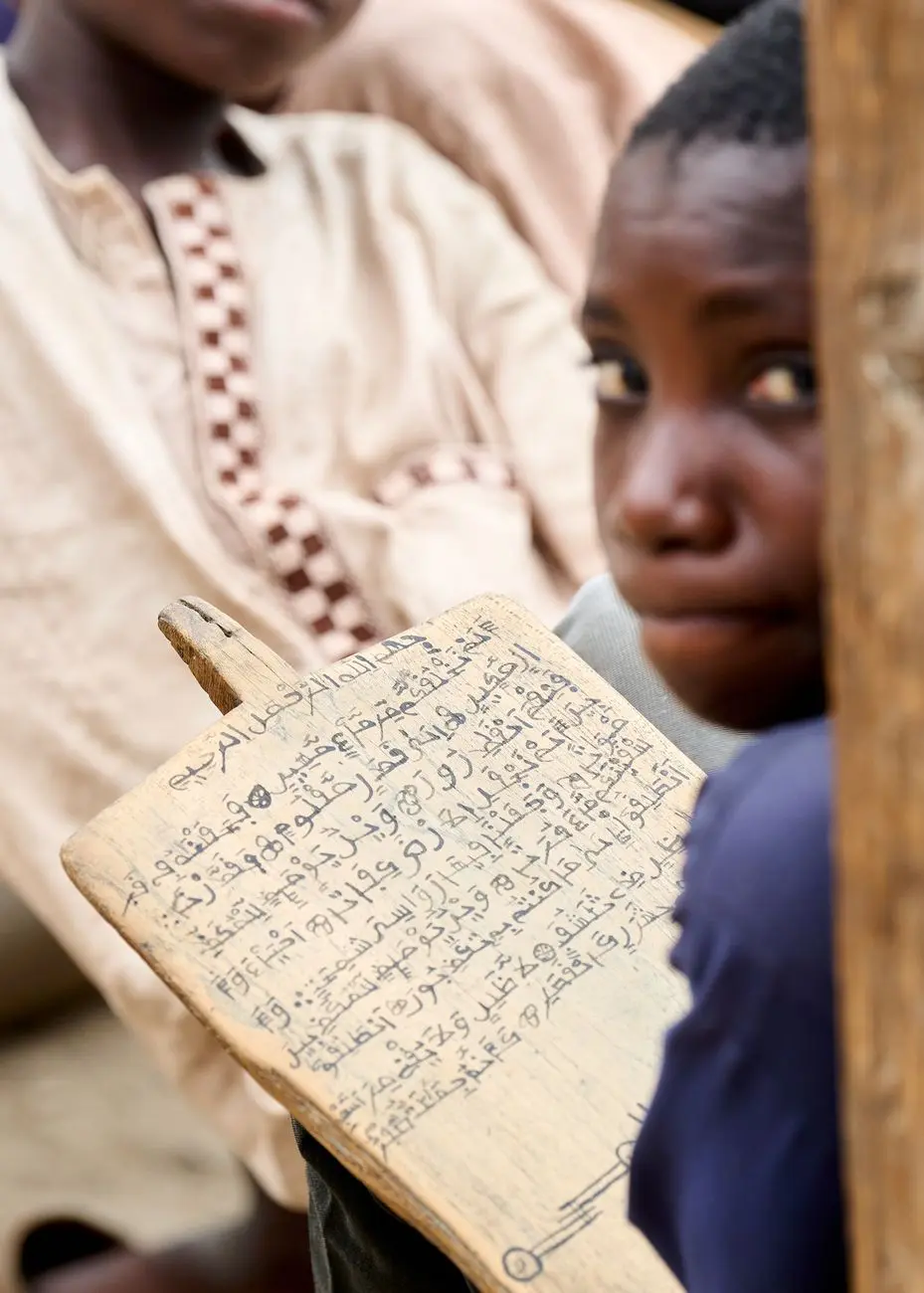 young student learning arabic script in classroom