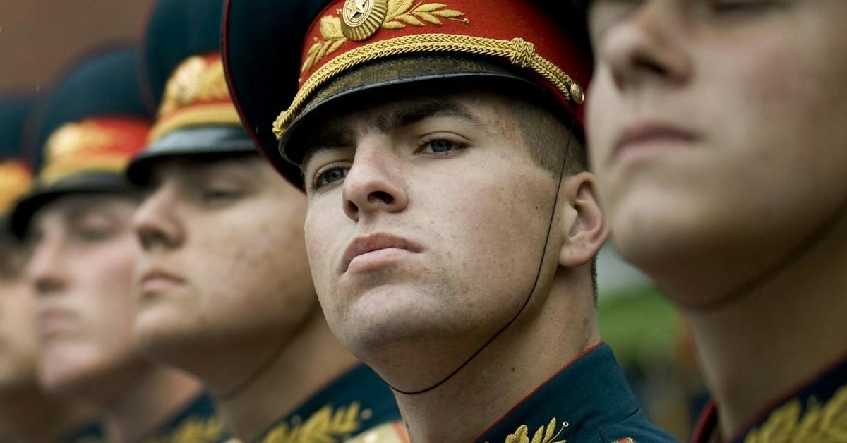 Russia Putin men in black and red cade hats and military uniform