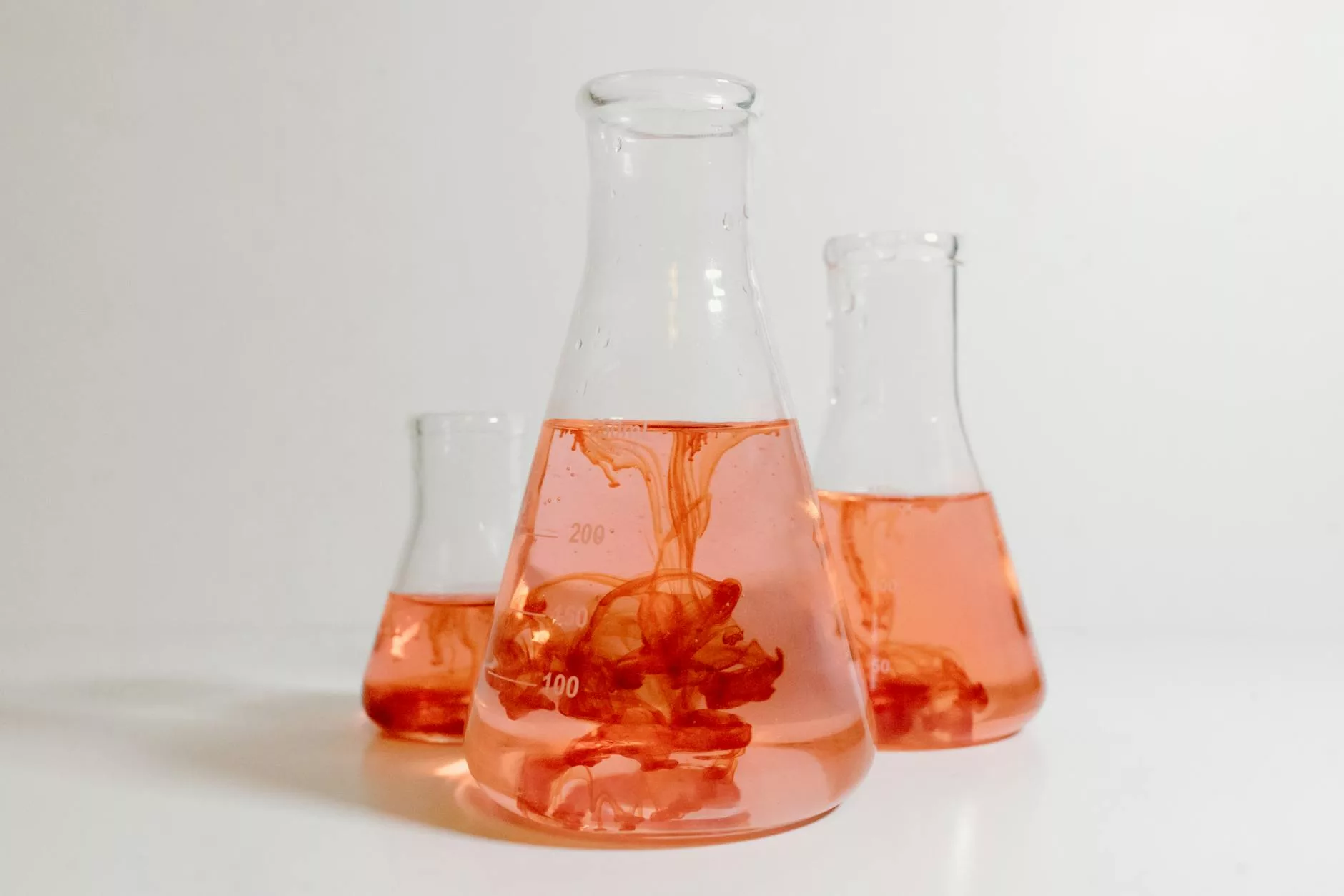elenmeyer flasks with red liquid inside
